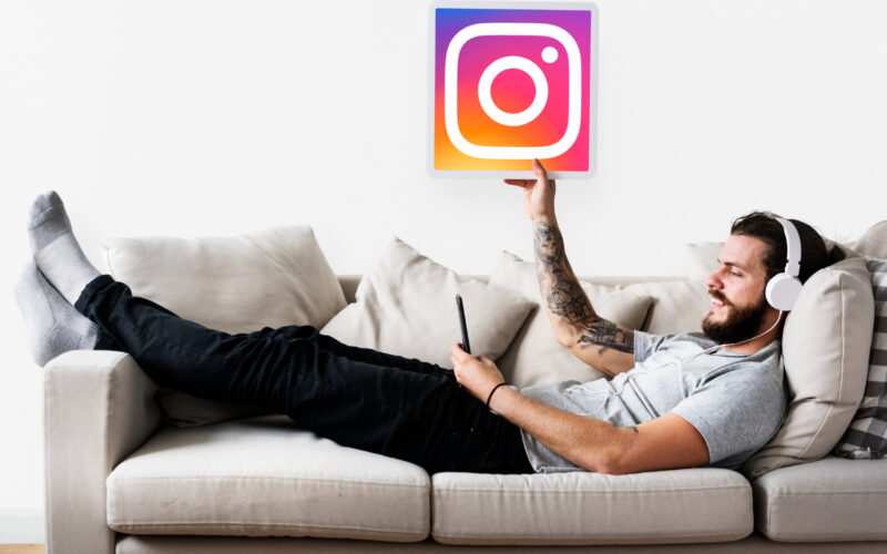 man on couch with instagram icon